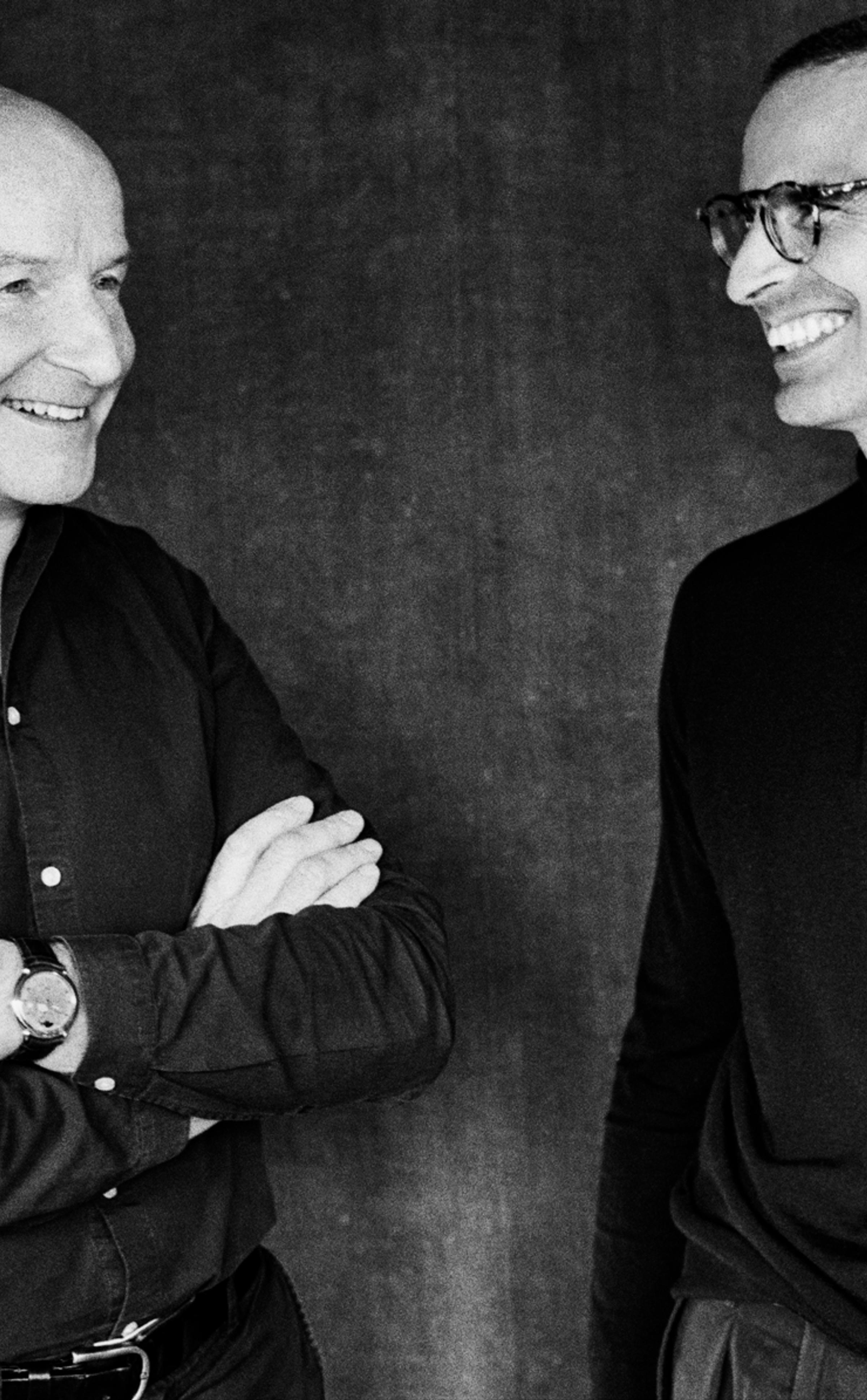 Kari Voutilainen and Alex Rosenfield sharing a moment, captured in a candid black-and-white portrait.
